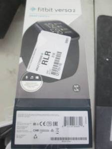lot 74 image: fit bit versa 2 powers on comes wit...