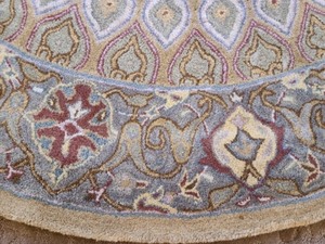 lot 23 image: Large Round Safavieh Wool Area Rug