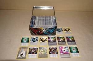 lot 54 image: Metal Tin of Pokemon Cards - Uncommons, Trainers, Energy