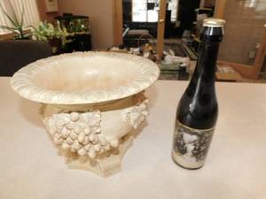 lot 28 image: Tan Carved Fruit Bowl  Bottle of Extra Virgin Oil