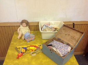 lot 173 image: Doll, Doll Clothes & Crib Mobile