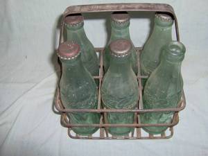 Coca Cola metal 6 pack carrier with original bottles. Prop of Okla Coca Cola Bot co stamped on handle. As shown.