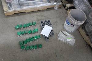 lot 643 image: Lot of (58) Industrial Roller Hardware  with Pole Mounting Bracket (x23), PVC Spacer 2-12Dx1-12W (x32), J Hook Unit 10 with Nut (in package x3), Misc. Mounts and Hardware