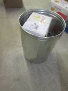 metal garbage can with small dents ...