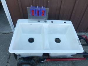 Cast iron porcelion 2 compartment sink. New. Has small chip on corner. As shown.