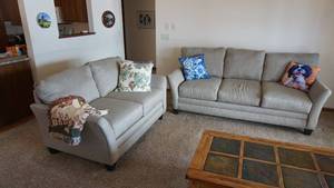 lot 1 image: Hennen Furniture Tan Sofa and Love Seat
