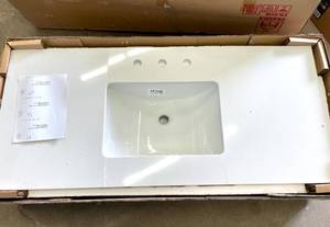lot 31 image: Engineered Marble Vanity Top in Snowstorm with White Single Trough Sink CRACKED 49 in. W x 22 in. D