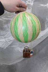 lot 130 image: Authentic Models Travels Light Hot Air Balloon Basket Dcor Green (in box)