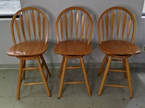 lot 394 image: Three Wood Counter Height Swivel Chairs