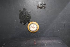 lot 14 image: NAVTIVE AMERICAN CLOCK AND METAL HANGING DECORATIONS