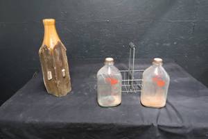lot 20 image: GLASS MILK JUGS WITH A CEDER WOODEN STATUE OF AN OLDER MILK JUG