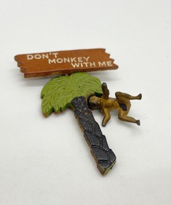 lot 18 image: 1950s Dont Monkey With Me Leather & Brass Brooch Pin