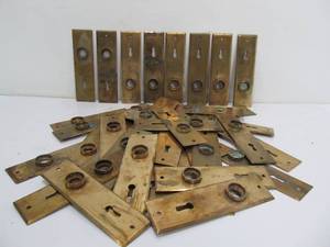 lot 139 image: Lot of 38 Matching Antique Brass Door Hardware Keyhole Plates