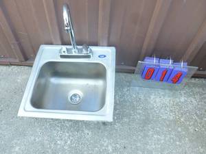 Stainless bar sink with faucet. Missing one handle. As shown.