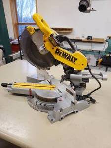 lot 8 image: 12 Dewalt Sliding Compound Miter Saw with Laser for persicion Cutting