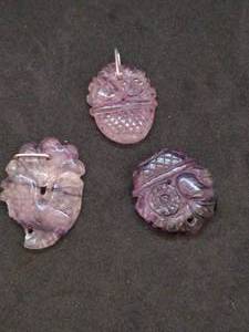 lot 148 image: Three Purple Stone Hand Carved Pendants