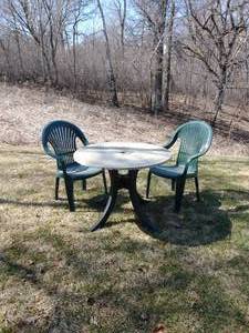 Two Plastic Chairs And Table
