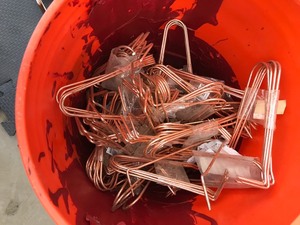 lot 38 image: Pipe hooks, multiple packs almost a 5 gallon bucket full