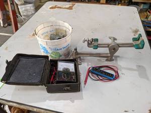 lot 294 image: Lowrance Electronics Stand  Clamp, Battery Tester, Amprobe Multimeter and More