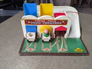 lot 482 image: Vintage Fisher Price Dump Truckers w 3 Trucks and 1 Wooden Little People Figure