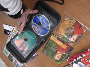 lot 67 image: Lot of assorted CDs in a zip aroun...