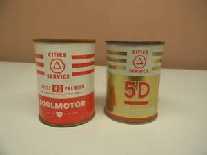 lot 119 image: VINTAGE KOOLMOTOR TRIPLE HD PREMIUM OIL CAN BANK & KOOLMOTOR 5D OIL CAN BANK - NICE SET - SEE PICTURES