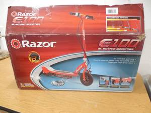 lot 65 image: Razor E100 12V Electric Scooter  Red