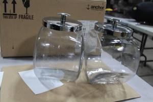 lot 526 image: Lot of (2) Anchor Hocking Glass Penny CandyCookie Jar with Stainless Steel Lid 8Wx5Dx9H (in 1 box)