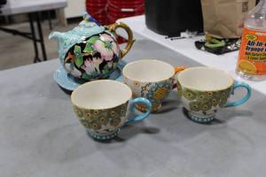 lot 730 image: Blue Sky Handpainted Ceramic Tea Pot  with Coastline Imports Dutch Wax Saucer and Cups (x3)