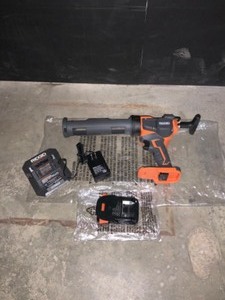 RIDGID 18-VOLT CORDLESS CAULK GUN AND ADHESIVE GUN WITH 1.5 AH LITHIUM-ION BATTERY. SEE PICTURES