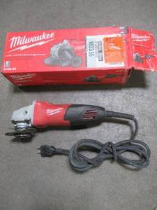 lot 29 image: Milwaukee 7 Amp Corded 4-12 in. Small Angle Grinder, 6130-3, Used. Missing Handle and Type 27 Guard.