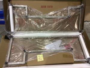 lot 76 image: Athena 45 in. NickelClear Large Rectangle Glass Coffee Table with Shelf Customer Returns See Pictures 