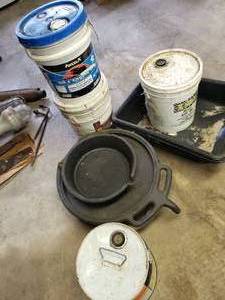 lot 66 image: (3) 5 Gallon Pails of Oil Unknown Levels, and (2) Oil Pans
