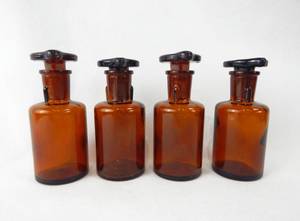lot 159 image: Set of 4 Vintage Mercer Glass Works Merco 60 ML Amber Glass Flat Top Grooved Stopper Dropping Bottles