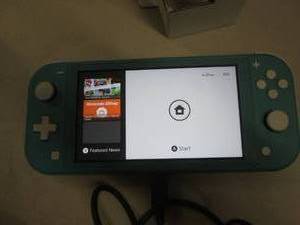 lot 71 image: nintedo switch lite and 11 in 1 acc...