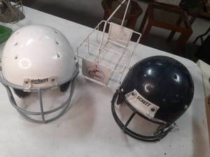 lot 66 image: Two padded Schutt Football Helmets each with a face guard, both size Medium and a Strong Wire basket type Water BottleDrink Carrier