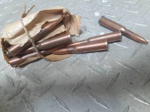lot 76 image: Small Unmarked brown bag package of ammo. Although its for a rifle, the specific calibergauge of shot gun is not known to us