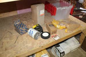 lot 1656 image: Lot of Tractor Supplies  with Oil Filter 86542664, John Deere Oil Filter RE59754, Pioneer ISO Nipple for Skid Loader Hydraulic Line, New Holland Element Assembly 221409, Caterpillar Cover 163-6813