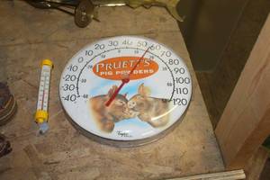 lot 1678 image: Lot of (2) Thermometers  with Pruetts Pig Powders 12 Wall Mount, Acu-rite Tube Style