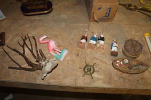 lot 1677 image: Lot of (9) OceanSea Themed Table Dcor  with Sailors, Flamingo, Nautical Helm, Life Boat, Tree
