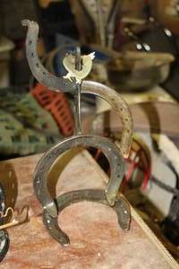 lot 1668 image: Handmade Metal Cowboy Horseshoe Figurine 12H
