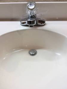 lot 27 image: Marble Vanity Top, Delta Faucet, Mirror & Light Bar