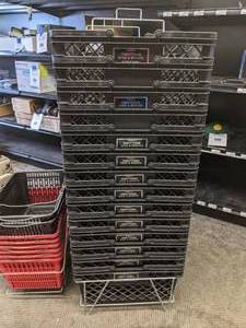 lot 125 image: Large Lot of Plastic Shopping Baskets with Storage Racks