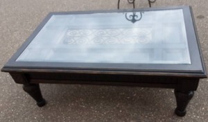 lot 59 image: Glass Top Wood coffee Table With Ornamental Iron Inlay 51x33x19