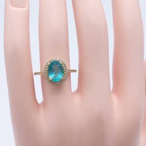 lot 4 image: Pretty Blue Crystal Ring with a Halo of White Crystals in 10K Gold.