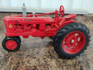 lot 86 image: Mc Cormic Farmall Tractor and Ertl Water Pump