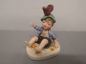 lot 64 image: Napco Ceramic Figurine Boy with Boot