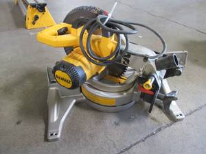 lot 68 image: DEWALT 10 in. 15 Amp Compound Miter Saw, DWS713. Used. Missing minor parts - Works.