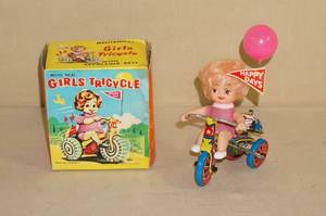 lot 24 image: Antique Mechanical Girls Tricycle Toy