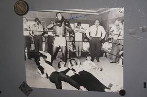 lot 111 image: Muhammad Ali Signed Photo - Standing Over The Beatles